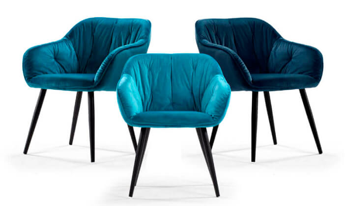 Collection of three velvet dining chairs on a white background